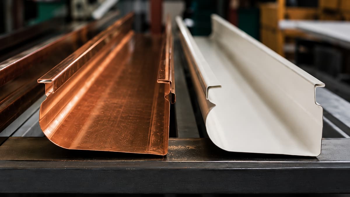 Homeowner discussing whether copper gutters are worth the investment with a professional installer in Fairfield County